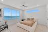 Large windows featuring water scenery, additional clerestory window, recessed lighting, and a modern ceiling fan