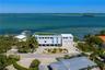 Waterfront property featuring a rooftop terrace, multi-level construction, attached two-car garage, and private dock