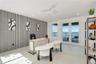 Accent wall with vertical paneling, light-toned flooring, white ceiling fan, and double glass doors providing external water-front access