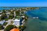 Waterfront property featuring a private dock, multi-level structure, rooftop terrace, and direct access to open water