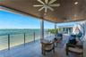 Covered terrace featuring a slatted wood ceiling, recessed lighting, ceiling fans, large-format tile flooring, and a stainless steel cable railing sys
