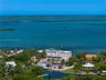 Waterfront property featuring a private boat dock, swimming pool, and direct canal access, situated on a lot with mature tropical landscaping