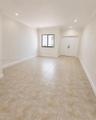Neutral-toned ceramic tile flooring, recessed lighting, crown molding, double doors, and a single-pane window
