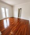 Room featuring wood-finish flooring, crown molding, and glass-paneled double doors