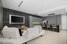 Modern kitchen featuring matte grey flat-panel cabinetry, integrated appliances, a dark wood-finish island with breakfast bar seating, recessed ceilin