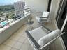 Covered balcony featuring tile flooring and a metal railing