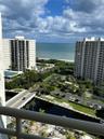 Elevated balcony featuring metal railings with ocean and coastal surroundings
