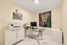 Interior room featuring high-gloss white built-in cabinetry, polished stone-finish flooring with grey veining, and a flush-mount square LED light fixt