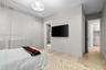 Light-filled interior featuring neutral wall tones, wood-finish flooring, and recessed ceiling lighting