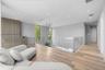 Open-concept space featuring wood-finish flooring, a glass panel railing, vertical wood-slat wall paneling, recessed lighting, and a modern tiered cha