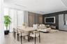 Open-concept living space featuring large-format tile flooring, a custom charcoal textured accent wall, floor-to-ceiling multi-panel feature wall, and