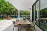 Covered patio featuring stone tile flooring, recessed ceiling lighting, and floor-to-ceiling sliding glass doors