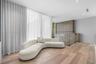 Wood-finish flooring, floor-to-ceiling wall treatments, recessed ceiling lighting, and a glass-paneled railing