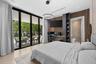 Floor-to-ceiling sliding glass walls, custom wood-slat accent wall, built-in office cabinetry, neutral large-format tile flooring, and minimalist circ