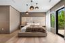 Custom full-height stone-textured headboard wall, light-toned wood-finish flooring, trio of suspended pendant lights, and floor-to-ceiling glass slidi