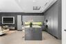 Modern kitchen featuring a central island with a waterfall edge, floor-to-ceiling flat-panel cabinetry, a horizontal ribbon window, integrated built-i