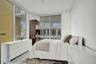 Floor-to-ceiling windows, sliding glass door, white wall finishes, and light-toned flooring
