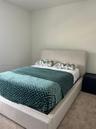 Neutral-toned interior space featuring light-colored wall paint and carpeted flooring