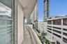 Curved balcony featuring a concrete floor and a metal mesh railing