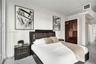 Built-in floor-to-ceiling dark wood cabinetry, white wood-finish flooring, and exposed ceiling ductwork