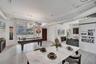 Open-concept living space featuring high ceilings with exposed ductwork, wood-finish flooring, floor-to-ceiling glass sliding doors, and a rustic slid