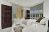 Floor-to-ceiling windows, neutral interior paint, and light-toned flooring