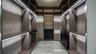 Custom walk-in closet featuring extensive built-in cabinetry, integrated LED strip lighting, open shelving, a multi-drawer dresser unit
