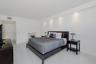 Spacious interior featuring glossy tile flooring, recessed ceiling lighting, and a neutral wall palette