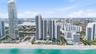 High-rise coastal towers featuring direct beach access, multiple outdoor swimming pools, expansive sun decks, and proximity to inland waterways