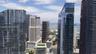 Urban skyline encompassing high-rise glass-facade structures, architectural tower variations, and waterfront exposure