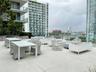 Expansive outdoor terrace featuring concrete flooring and a glass railing