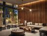 Floor-to-ceiling windows, natural wood-paneled walls, large-scale sculptural metal pendant lighting, and polished stone flooring