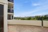 2nd expansive private terrace featuring patterned paver flooring, perimeter walls with gorgeous sunset views.