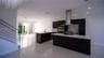 Kitchen featuring dark cabinetry, quartz countertops, a stainless steel range hood, built-in wall oven, and polished tile flooring