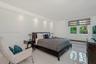 Neutral-toned tile flooring, recessed ceiling lighting, and horizontal shade window treatments