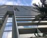 High-rise architectural exterior featuring glass-paneled balconies, concrete structural elements, and floor-to-ceiling windows