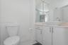 Bathroom featuring a vanity with high-gloss white cabinetry, a stone-composite countertop, a rectangular vessel sink, and a polished chrome faucet, co