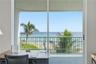 Enjoy beautiful Atlantic Ocean views and swaying palm trees from this oceanfront room, currently arranged as a home office.