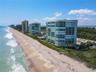 Beautiful perspective of Regency Island Dunes showcasing its direct oceanfront location, expansive sandy beaches, and private beach access.