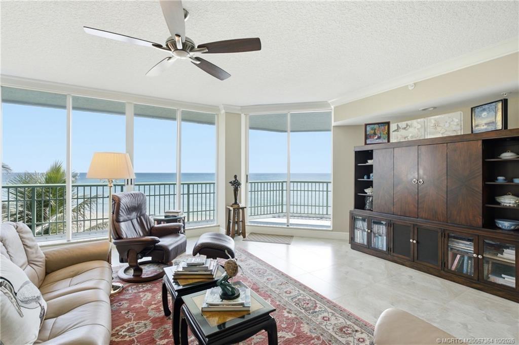 Beautifully positioned oceanfront living room with expansive glass and direct access to the balcony.