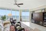 Beautifully positioned oceanfront living room with expansive glass and direct access to the balcony.