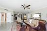 Generously sized living area with neutral tile flooring and an open layout ideal for entertaining.