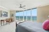Wake up to breathtaking Atlantic Ocean views from this spacious primary bedroom with floor-to-ceiling glass.