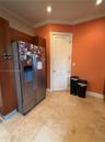 Stone-tile flooring, recessed ceiling lighting, and built-in wood-finish cabinetry
