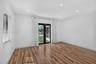 Wood-finish flooring, recessed lighting, and black-framed glass French doors