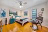 Wood-finish flooring, recessed lighting, ceiling fan with light fixture, and dual windows with horizontal blinds