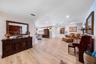 Open-concept interior featuring light-toned wood-finish flooring, recessed lighting, and dual-door entry
