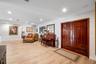 Double-entry front doors with polished wood finish, wood-finish flooring, and recessed ceiling lighting