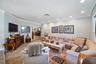 Living area featuring wood-finish flooring, recessed lighting, and crown molding