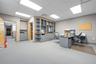 Interior office space featuring recessed ceiling lighting, wall-to-wall carpeting, and custom built-in cabinetry with integrated shelving